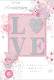 This anniversary card feels like a gentle celebration of enduring romance set against the cosy backdrop of East Dulwich, where familiar streets and local parks hold years of shared memories. The central focus is the word LOVE, rendered in soft, raised glitter that lends both visual sparkle and tactile interest. The letters are smooth and carefully shaped, with the O subtly echoing a heart, its shimmering silver texture contrasting beautifully with the surrounding blush pink tones. Pastel pinks and silvery greys blend across the design, creating an atmosphere of treasured intimacy, like lamplight spreading across a quiet room on a rainy evening. Encircling the central text, delicate blossoms in blush and mauve unfold in a style that feels almost like watercolour-soft edges, gentle transitions of colour, and a sense of petals just opening. Fine, flowing lines trace stems and tendrils, forming graceful curves that suggest both lightness and attentive care, much like a florist arranging a romantic bouquet for an East Dulwich anniversary dinner at home. Tiny extras-scattered petals, curling swirls, and subtle butterfly silhouettes-introduce motion and whimsy, as though a light breeze were drifting through an English spring garden. The background remains softly pink, allowing the raised glitter and floral lines to stand out while still feeling cohesive and calm. In delicate script, the words On Our Anniversary and I love you today and always are written with gentle sincerity, enhancing the card's emotional warmth. Altogether, it presents a quietly heartfelt keepsake, ideal to accompany fresh flowers delivered locally in East Dulwich for a meaningful anniversary celebration.